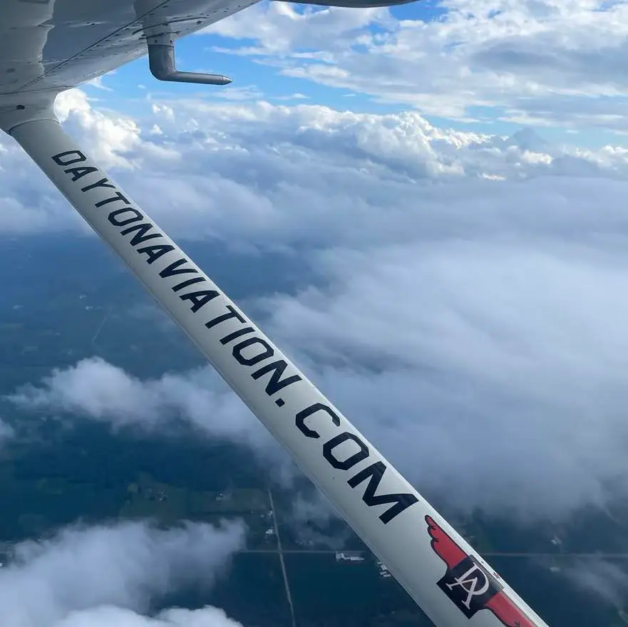 Aircraft wing above the clouds representing professional pilot career opportunities