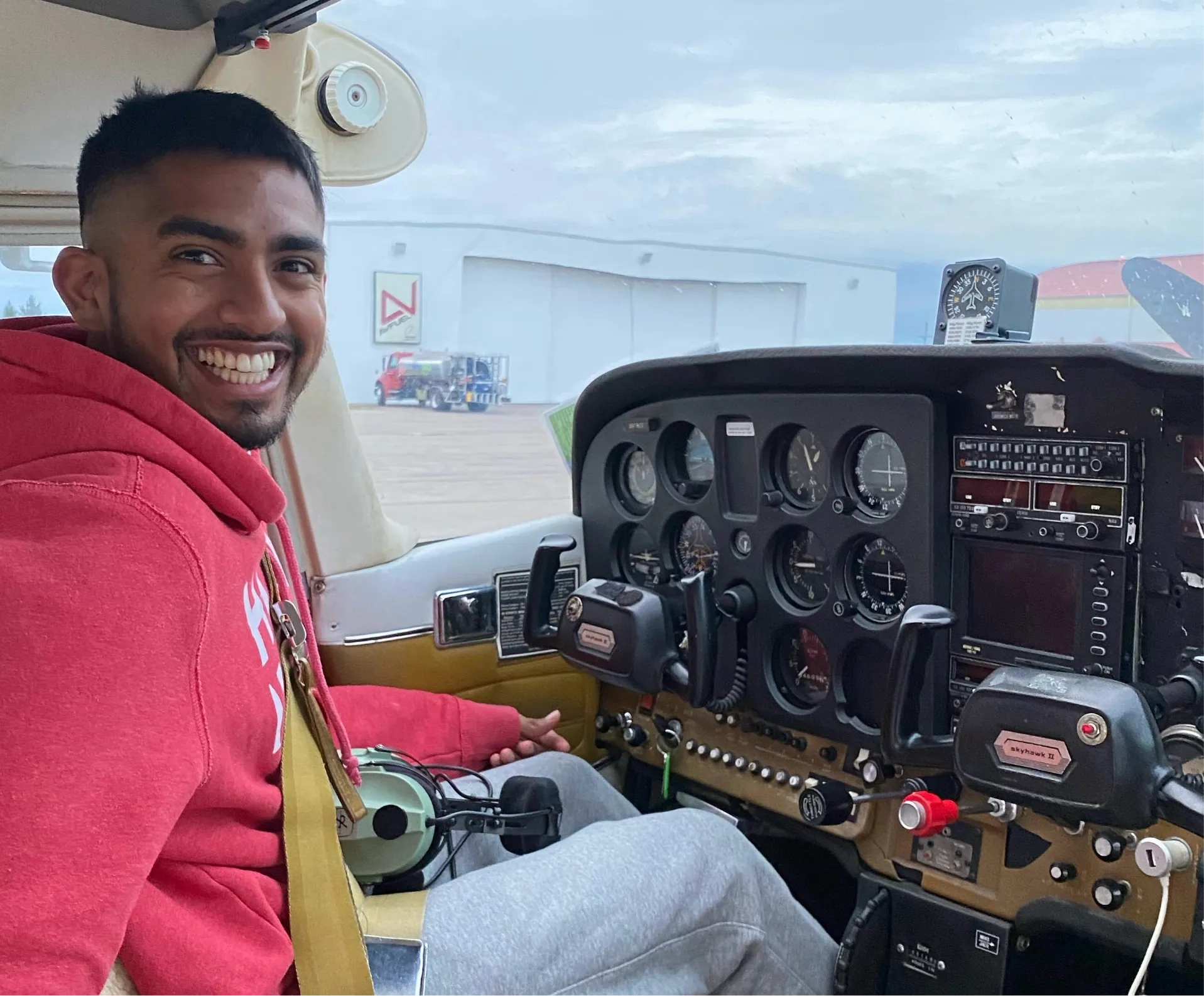 Student pilot smiling from the cockpit during flight training in Dayton, Ohio